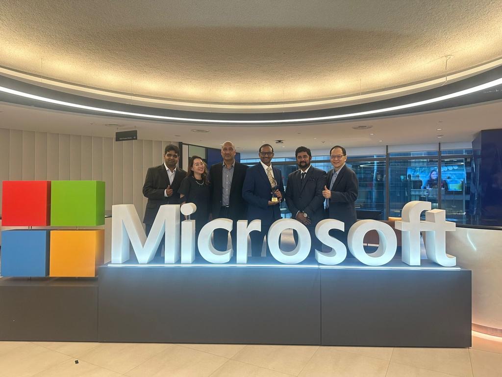 TeBS Team with CEO Radhakrishna Bijjala standing holding the Microsoft APR Partner of the Year 2023 - Social Impact award